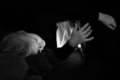 High angle view of girl using digital tablet while lying on sofa at home