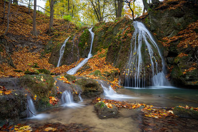 Waterfall in forest during autumn