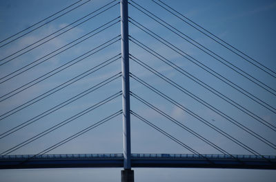 Low angle view of suspension bridge against sky