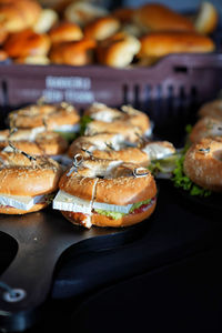 Close-up of bagels on plank at buffet