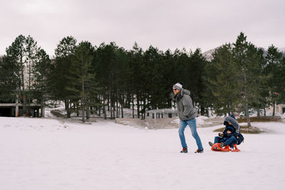 Man skiing on snow covered field