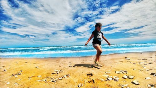 Full length of man on beach against sky