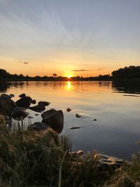 Scenic view of lake against sky during sunset