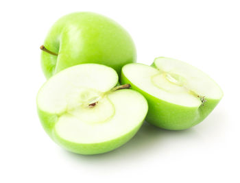 Close-up of green apple against white background