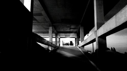 Man walking under bridge