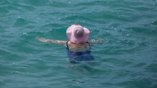 High angle view of man swimming in sea