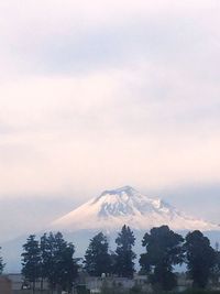 Scenic view of mountains against cloudy sky