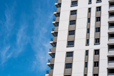 Low angle view of building against blue sky during sunny day