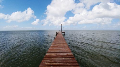 Pier over sea against sky