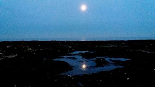 Scenic view of moon against clear sky at night