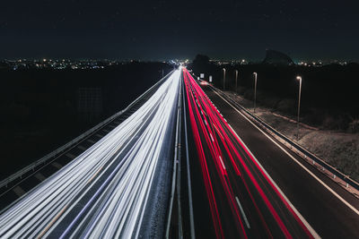 High angle view of light trails on road in city at night