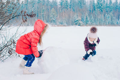 Full length of a girl playing in snow