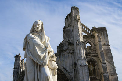 Low angle view of statue against sky