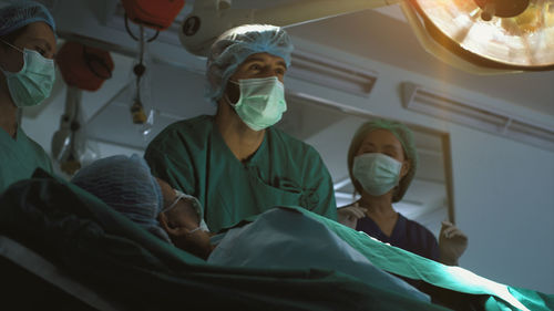 Rear view of doctor examining patient at clinic