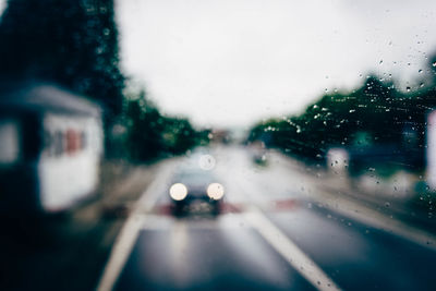 Close-up of wet car window in rainy season