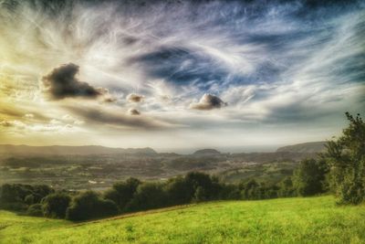 Scenic view of landscape against cloudy sky