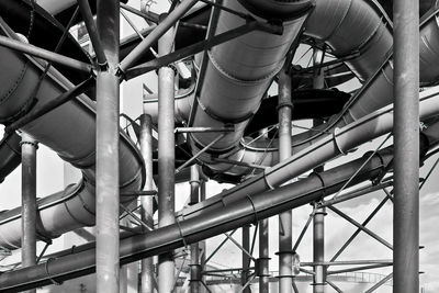 Low angle view of aqua park industry against sky in monochrome 