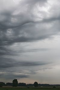 Low angle view of storm clouds over landscape