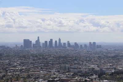 Aerial view of buildings in city against sky