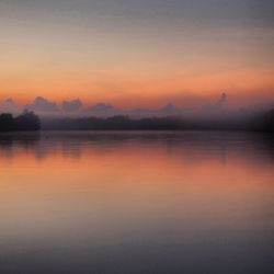 Scenic view of lake at sunset