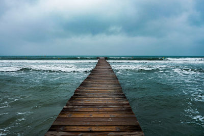 Pier over sea against sky