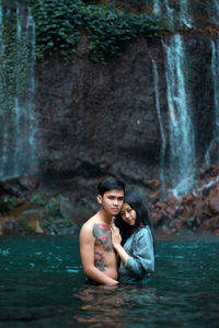 Portrait of young couple in river