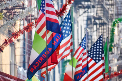 Italian and united states flags are seen at the feast of san gennaro, new york city.