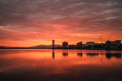 Scenic view of lake against romantic sky at sunset