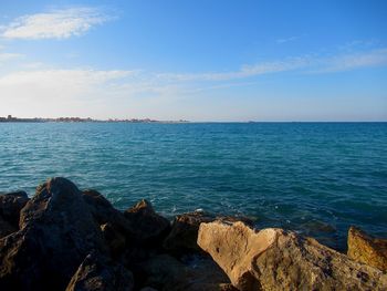 Scenic view of sea against blue sky