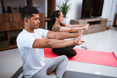 Young woman exercising at home