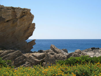 Scenic view of sea against clear blue sky