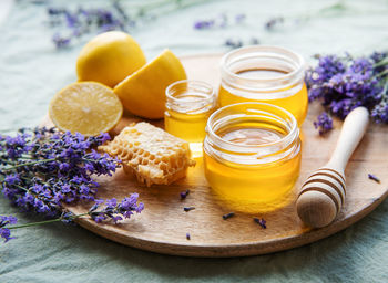 Glass of honey, honeycomb and lavender flowers