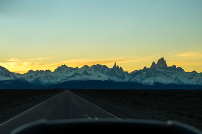 Scenic view of snowcapped mountains against sky during sunset