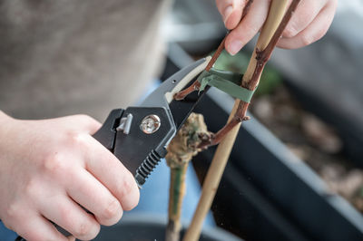 Cropped hand of man repairing machine