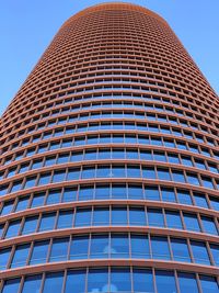 Low angle view of modern building against clear blue sky