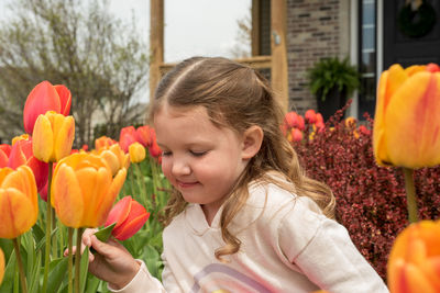 Close-up portrait of girl with tulips