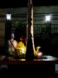 Full length of woman sitting on bench