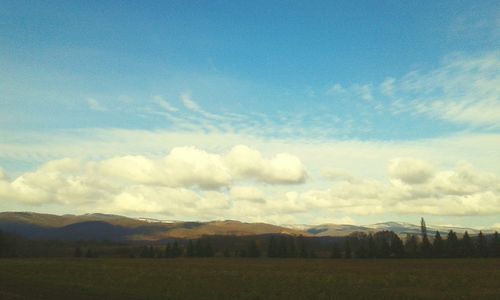 Scenic view of landscape against cloudy sky