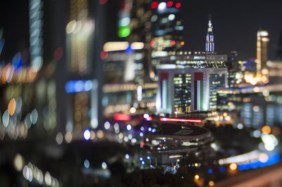 Tilt-shift image of illuminated cityscape at night