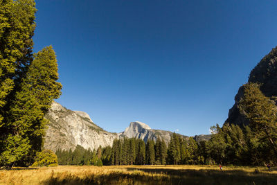 Scenic view of rocky mountains against clear blue sky