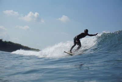 Full length of man splashing water in sea