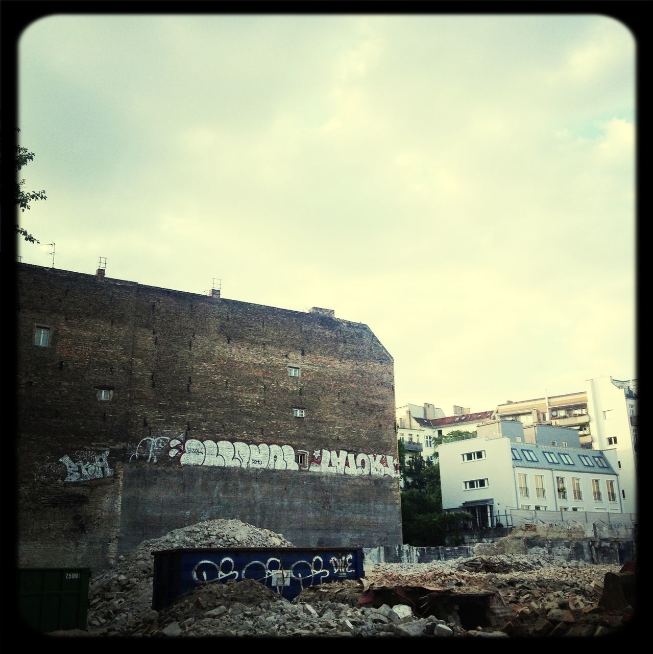 transfer print, auto post production filter, building exterior, architecture, sky, built structure, text, cloud - sky, day, western script, cloud, abandoned, outdoors, no people, house, communication, residential structure, low angle view, old, cloudy