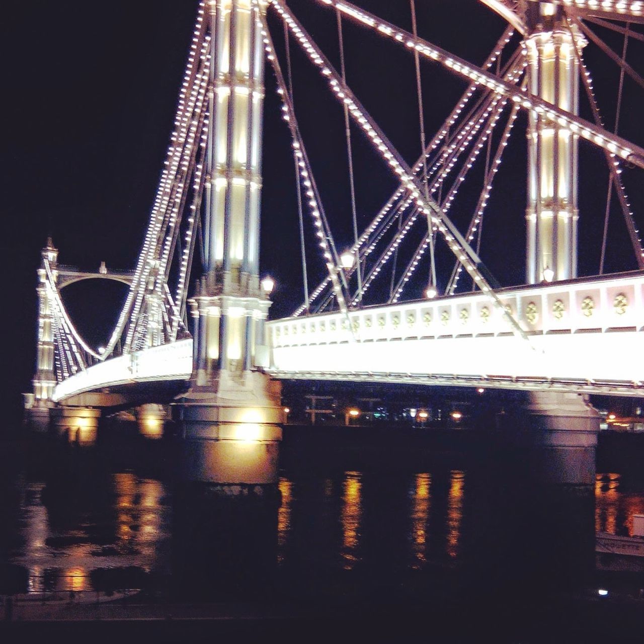 ILLUMINATED SUSPENSION BRIDGE AT NIGHT