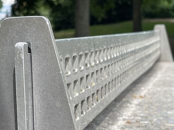 Close-up of empty bench in park