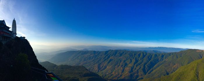 Scenic view of mountains against blue sky