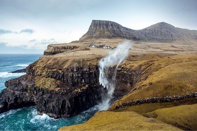 Scenic view of sea and mountain against sky