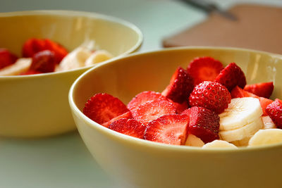 Close-up, bowls of sliced strawberries and bananas