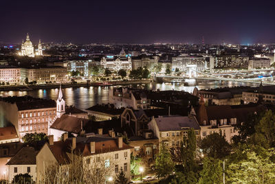 Aerial view of illuminated cityscape against sky at night