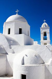 Low angle view of church against blue sky at santorini