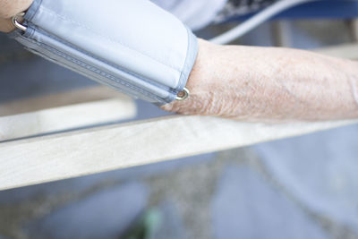 Cropped hands of person on parallel bars